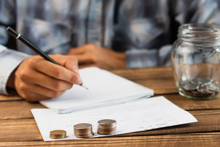 man-with-saving-jar-counting