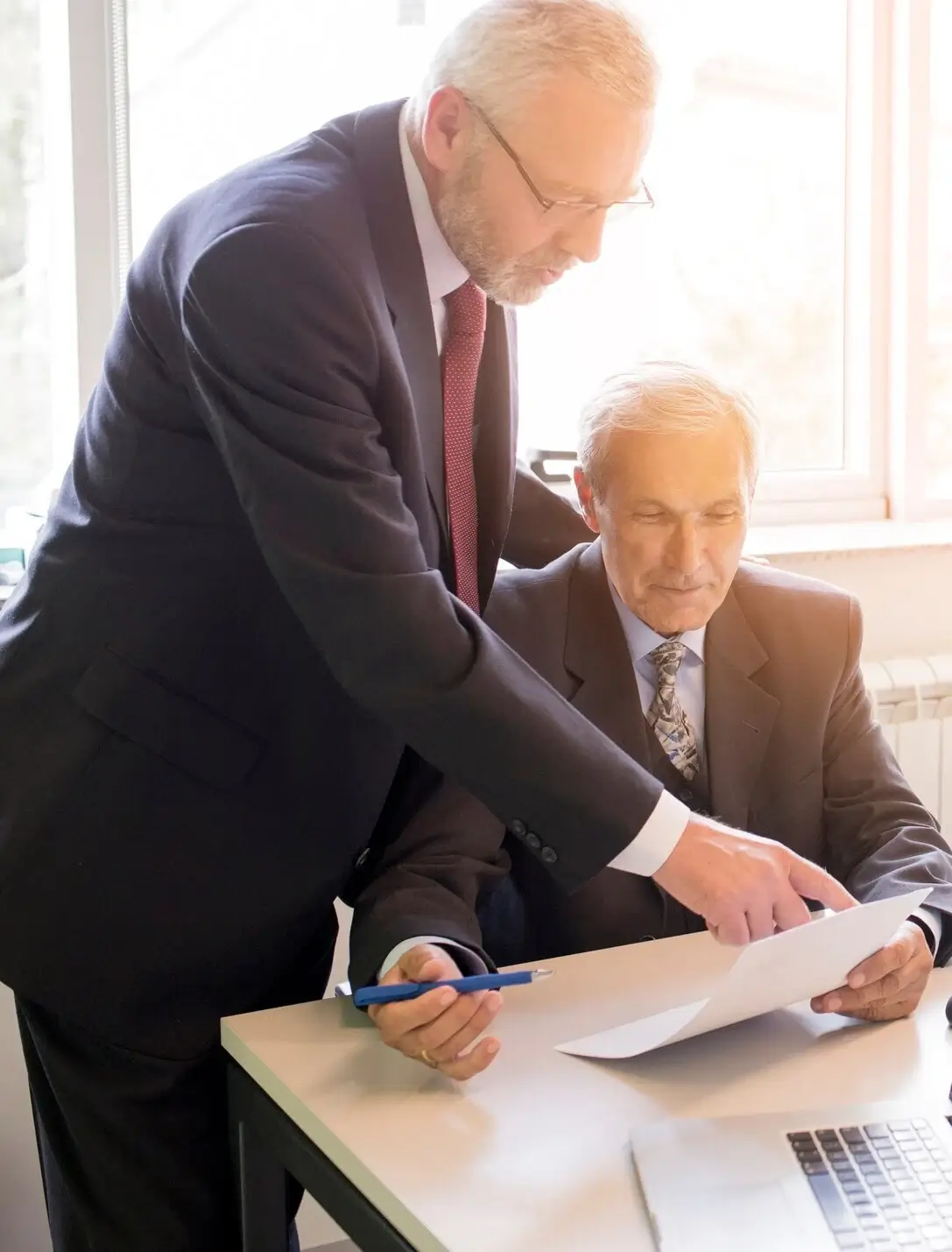 two-mature-businessman-discussing-business-project-office